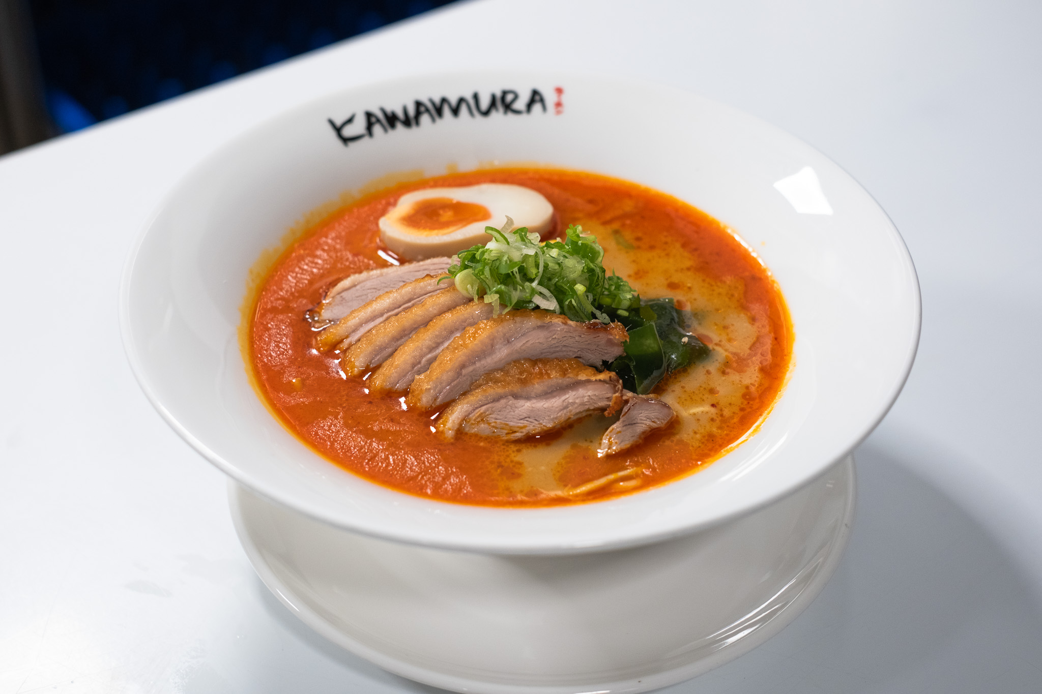 Spicy duck ramen with sliced duck breast, soft-boiled egg, and scallions at Kawamura Ramen Budapest