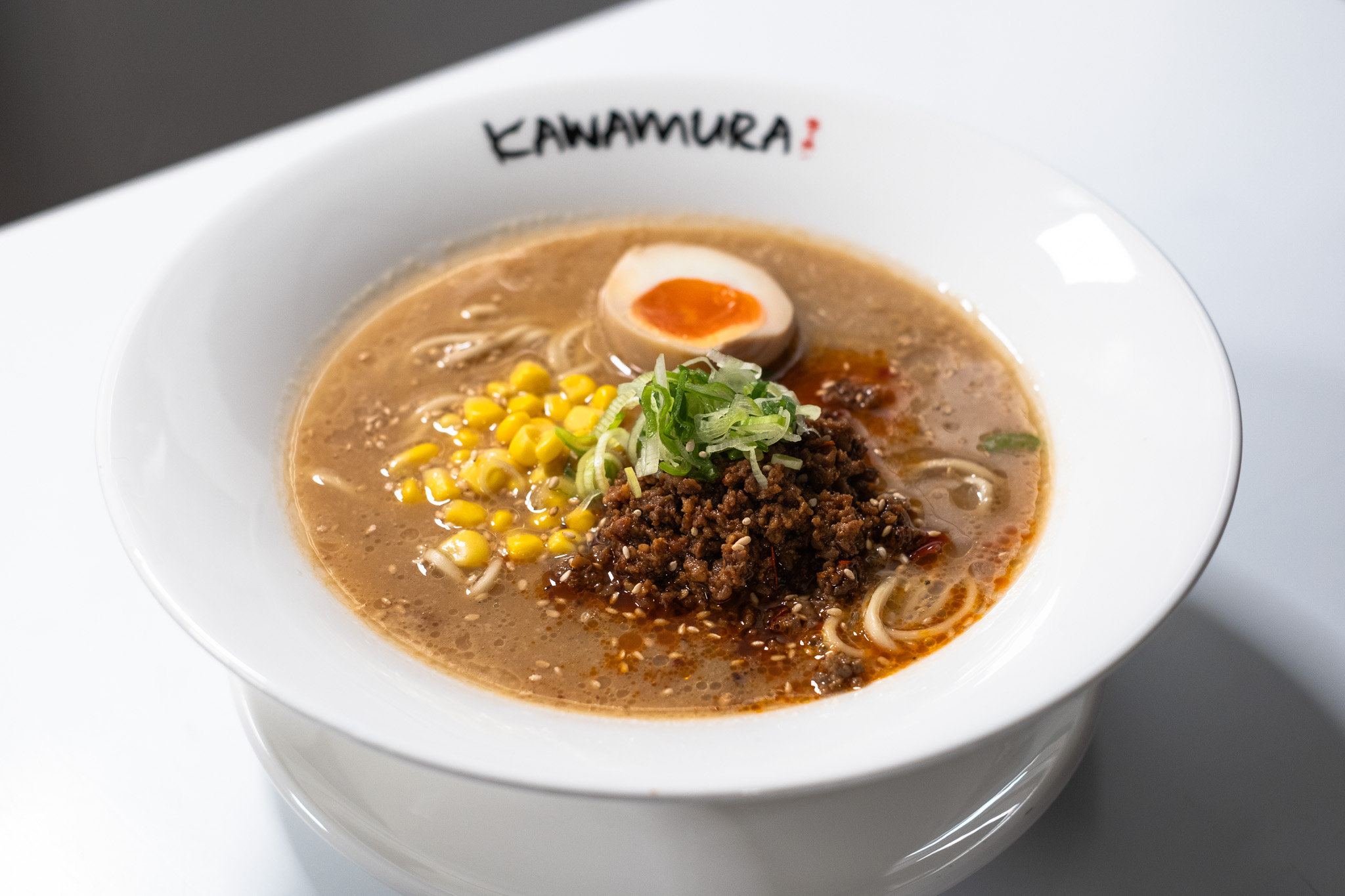Shoyu beef ramen with corn, ground meat, and soft-boiled egg at Kawamura Ramen Budapest