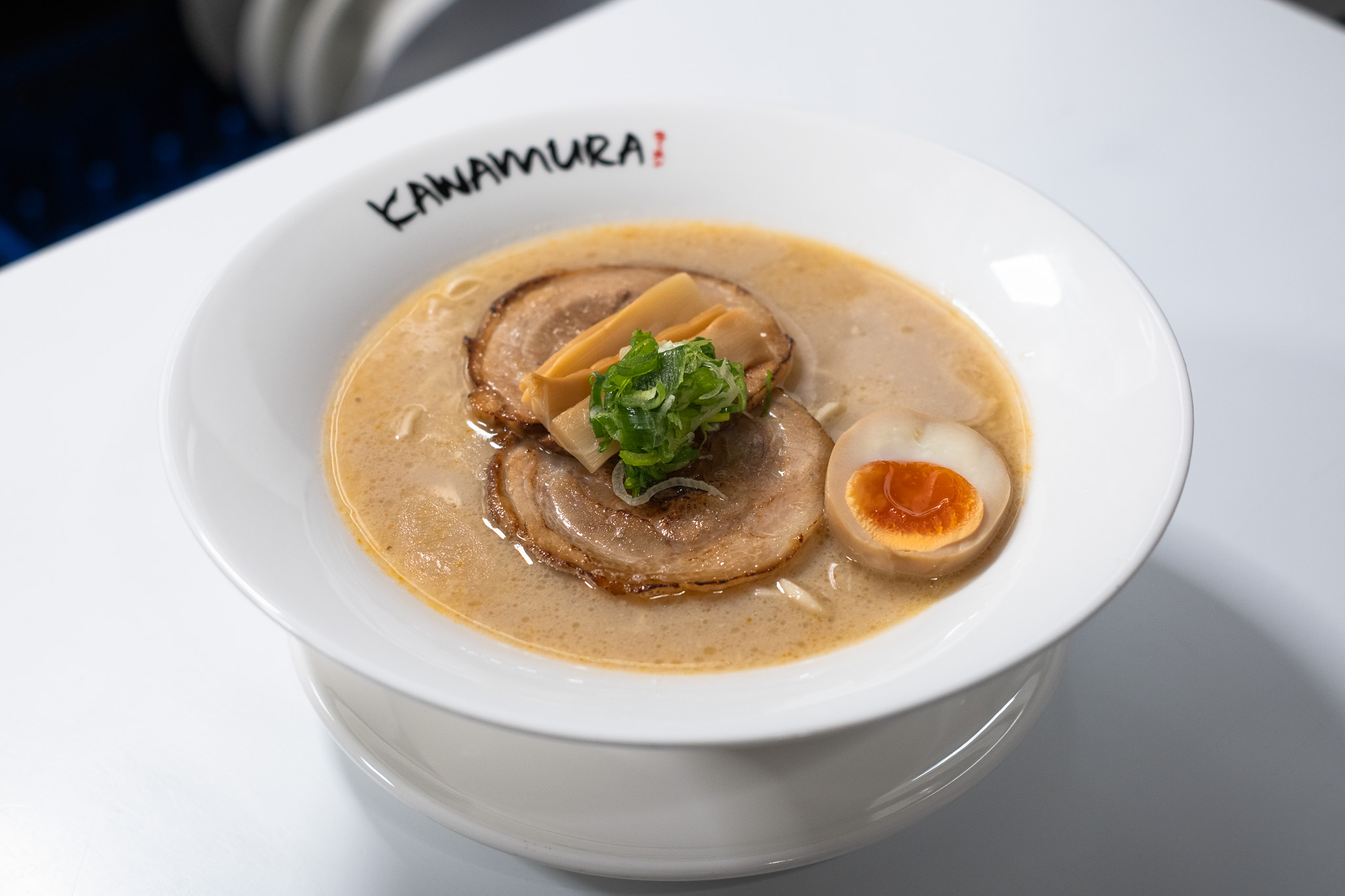 Shio tonkotsu ramen with chashu pork, bamboo shoots, soft-boiled egg, and scallions at Kawamura Ramen Budapest