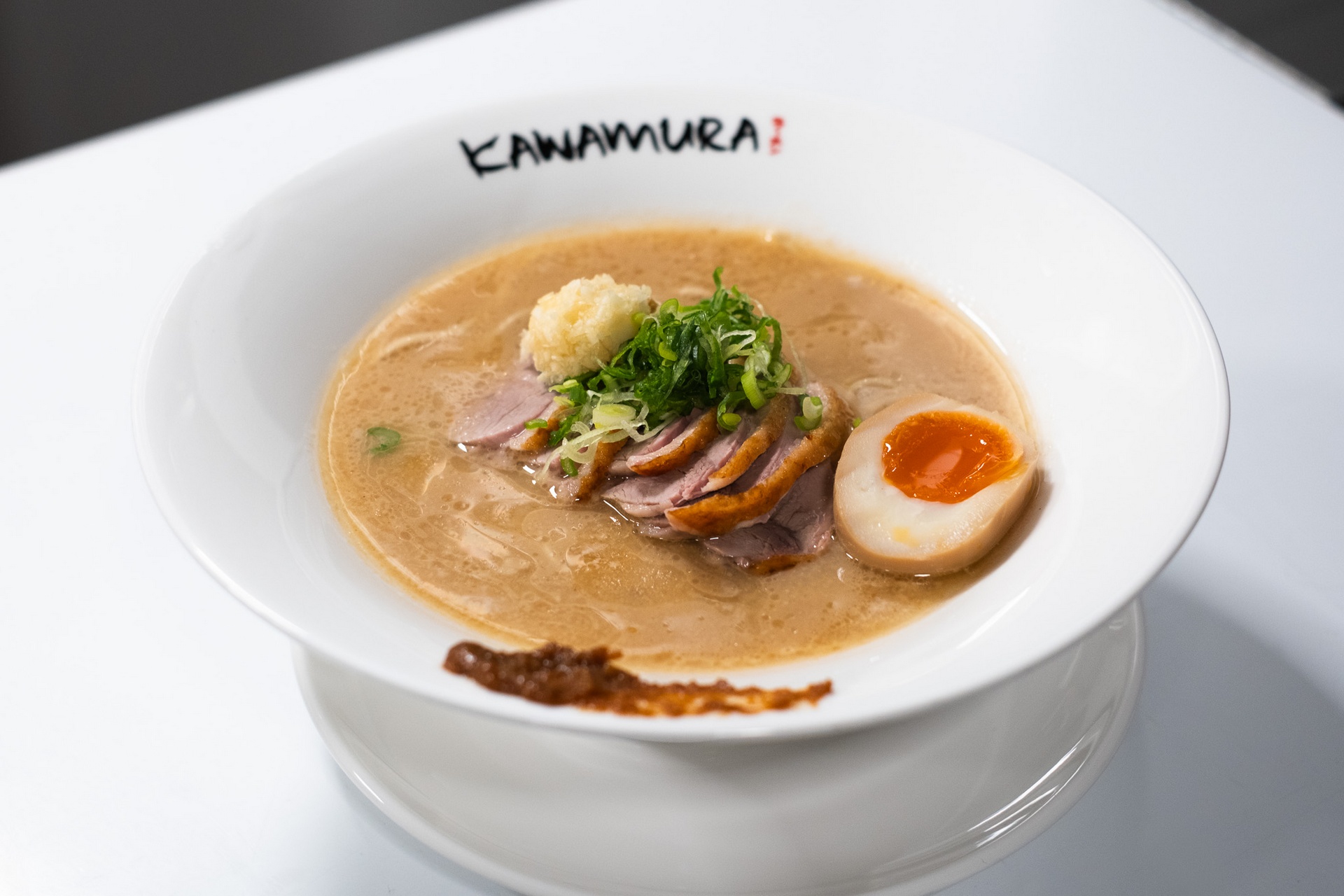 Kamo miso ramen with duck slices, soft-boiled egg, and scallions in miso broth at Kawamura Ramen Budapest