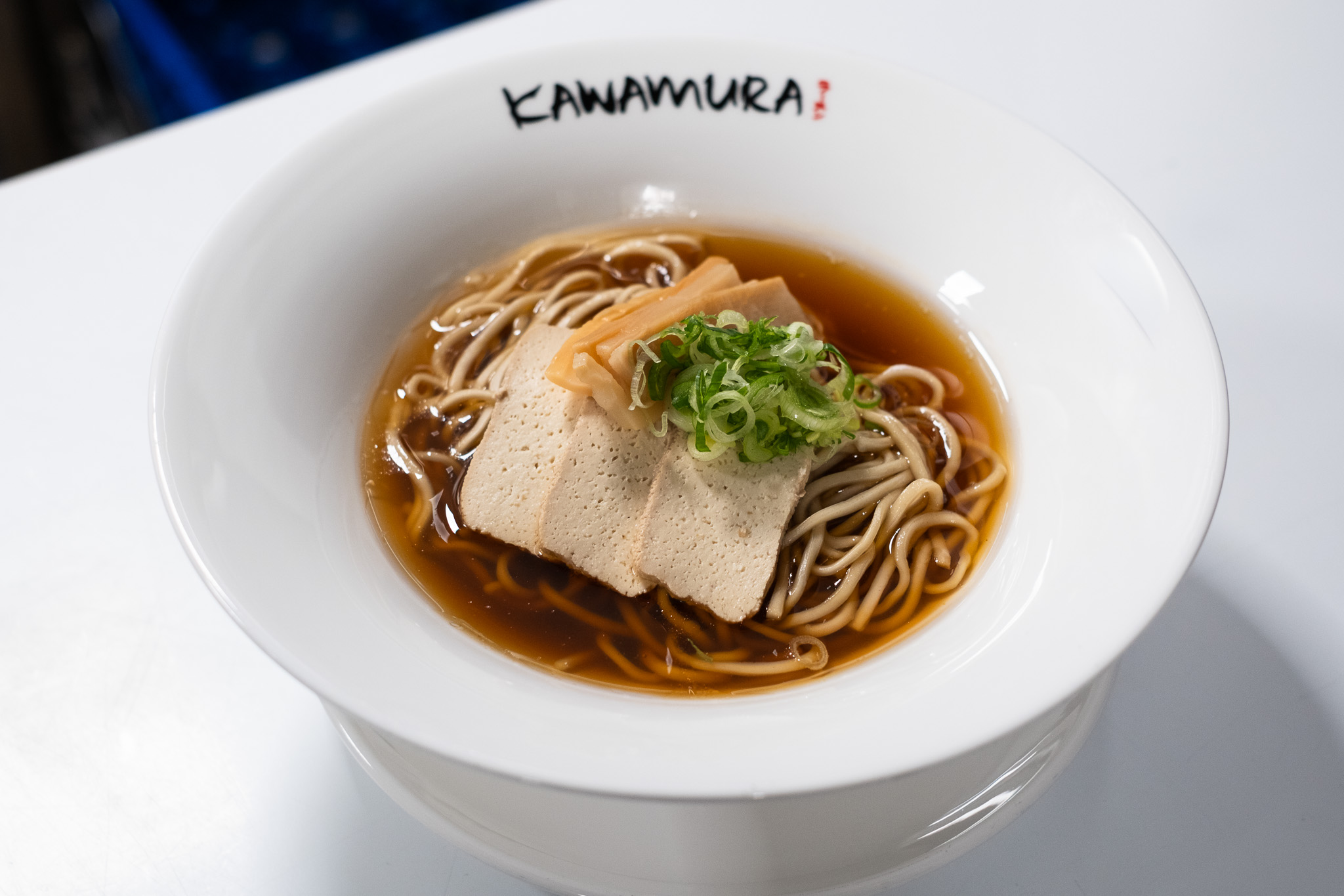Vegan shoyu ramen with tofu, scallions, and noodles in clear soy broth at Kawamura Ramen Budapest